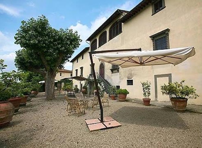 The inviting garden with umbrellas, tables, chairs and private pool